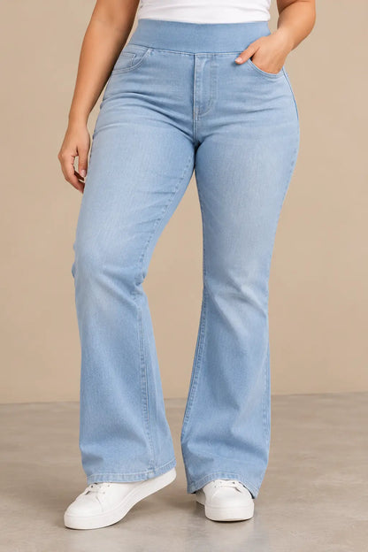 Pantalón Cashia Denim 200 en azul denim claro, talla XL, con cintura alta elástica y pierna ligeramente acampanada, mostrado en medio plano inferior sobre modelo de piel clara, con zapatillas blancas y fondo beige.