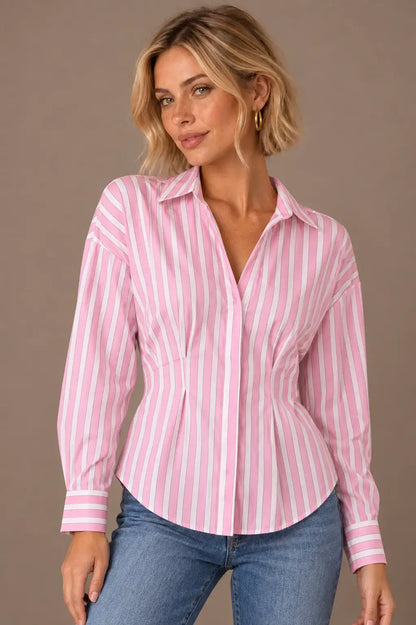 Modelo Cashia rubia de melena corta y pecas con Camisa Cashia Clara de rayas rosas y blancas en talla XS, en medio plano superior con vaqueros.
