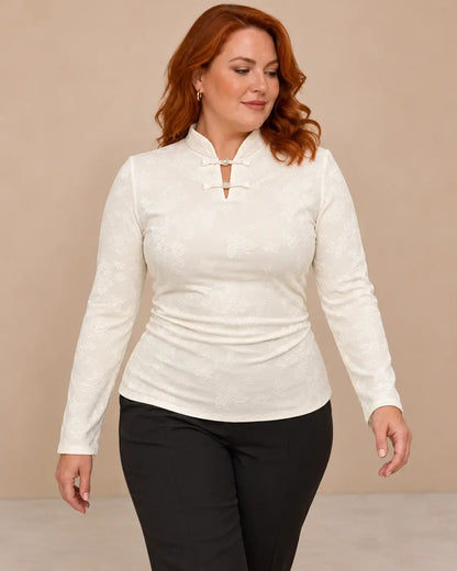 Camiseta mujer cuello mao detalle floral, de manga larga, con diseño elegante y ajuste cómodo, color blanco.