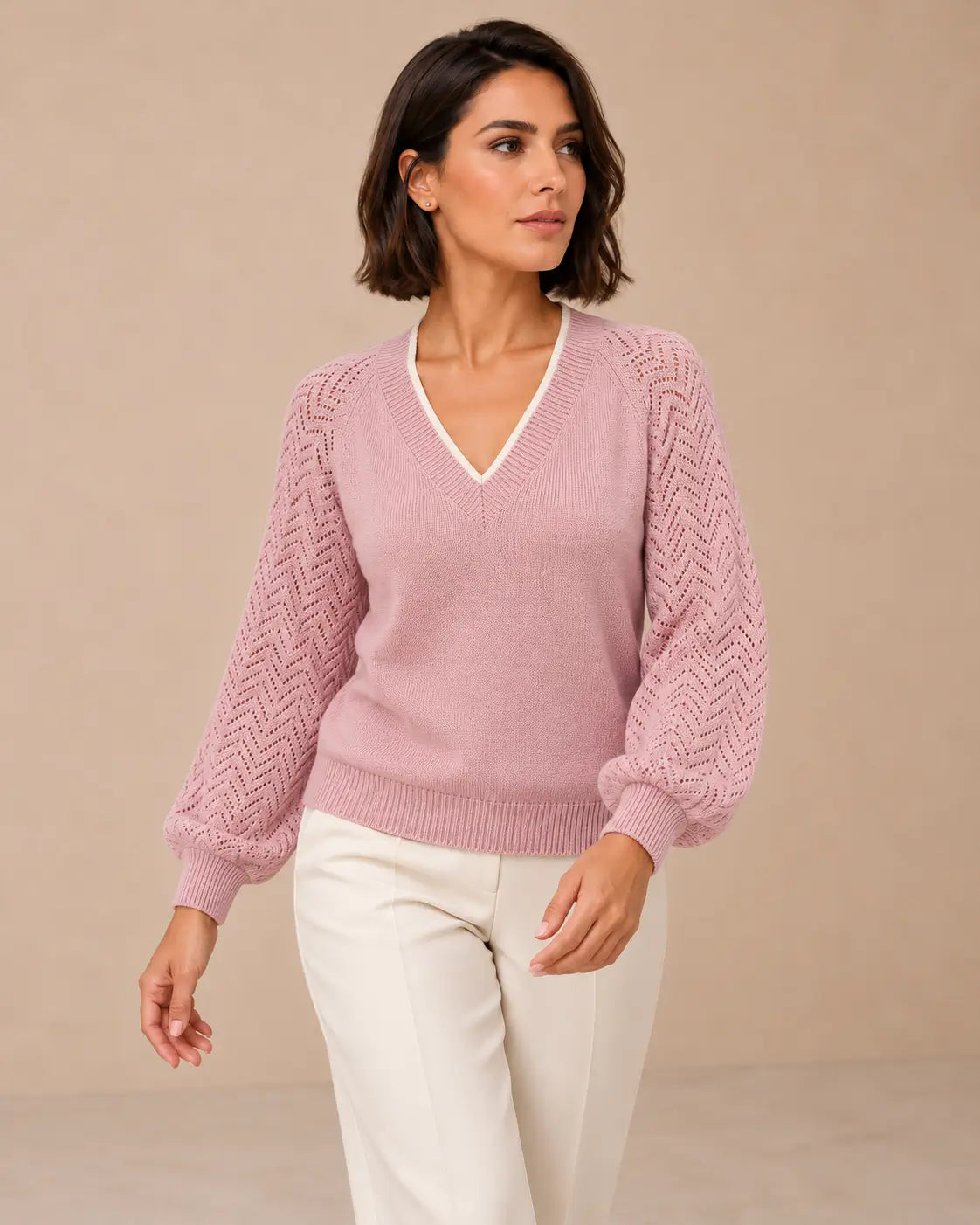 Modelo Cashia de cabello castaño en corte bob con jersey Saja rosa, talla M, medio plano superior.
