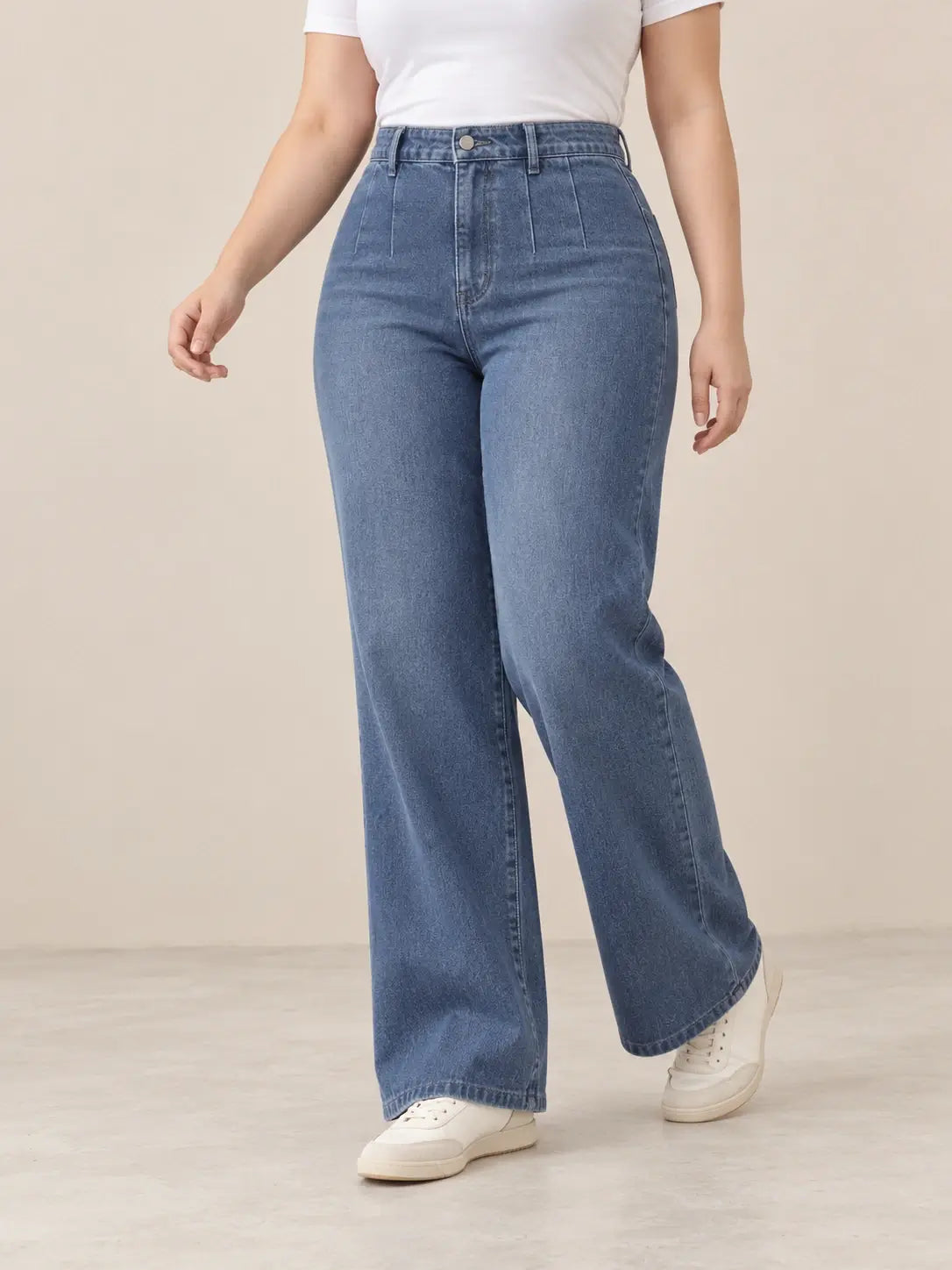 Pantalón Cashia Denim 401 denim medio, talla L, medio plano inferior sobre modelo, con tiro alto y pernera ancha.