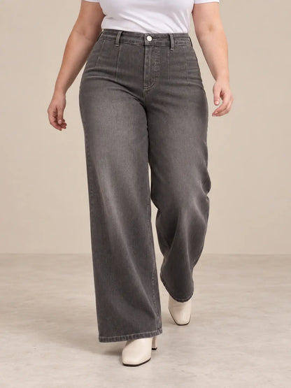 Pantalón Cashia Denim 401 gris, talla XL, medio plano inferior sobre modelo, con tiro alto y pernera ancha.
