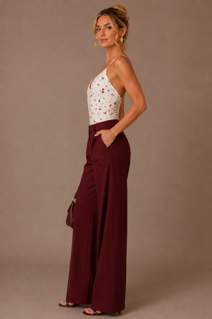 Vista de perfil del Top Cashia Portofino floral blanco combinado con pantalón burdeos wide leg.